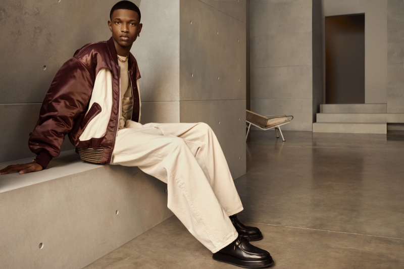 Sporting a bomber and relaxed-cut pants, Malik Anderson stars in AMBUSH's spring-summer 2021 men's campaign.