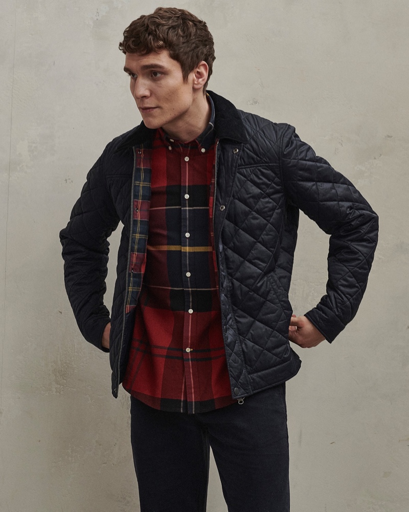 Front and center, George Admiraal wears a quilted jacket with a tailored shirt from Barbour's men's Tartan collection.