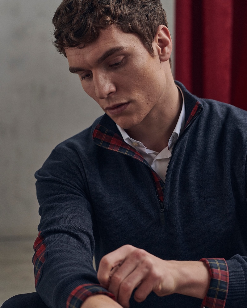 Connecting with Barbour for spring, George Admiraal models a crisp white shirt with a half-zip pullover from Barbour's men's Tartan collection.