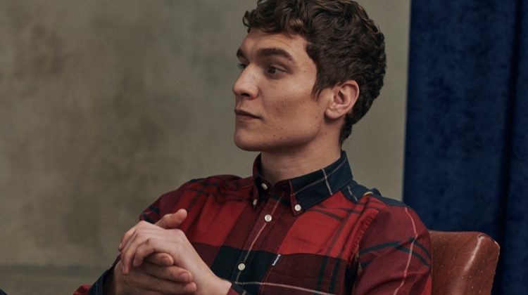 Relaxing, George Admiraal wears a red tailored shirt from Barbour's new Tartan collection.