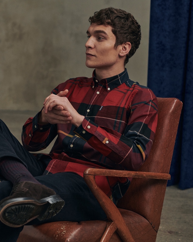 Relaxing, George Admiraal wears a red tailored shirt from Barbour's new Tartan collection.