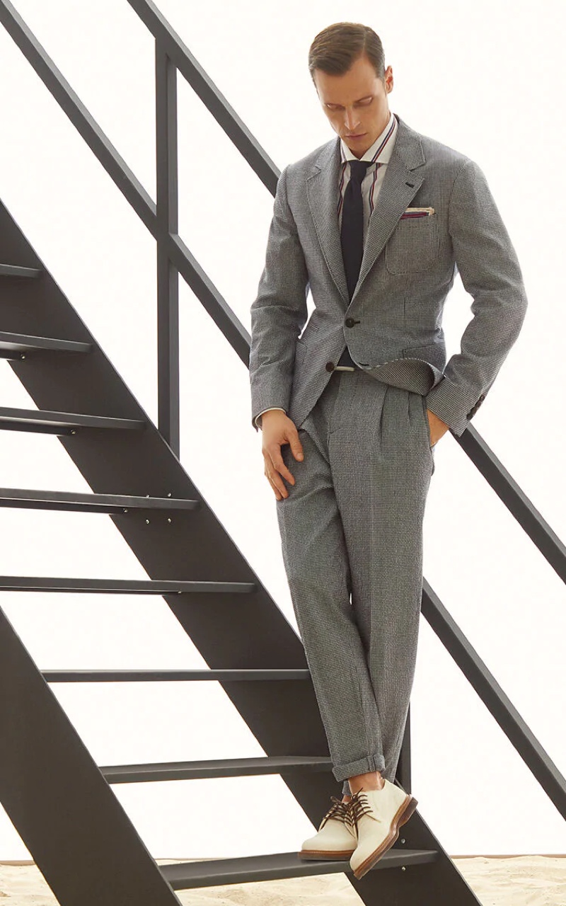 Model Lars Burmeister sports a comfort virgin wool checked seersucker deconstructed suit from Brunello Cucinelli.