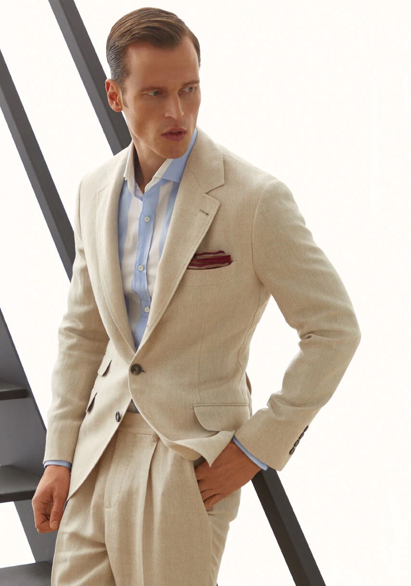 Front and center, Lars Burmeister dons a Brunello Cucinelli linen, wool, and silk chevron deconstructed suit.