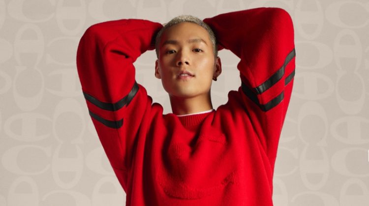 Jeffrey Tung sports a red pullover and black joggers from the Coach x Champion collection.