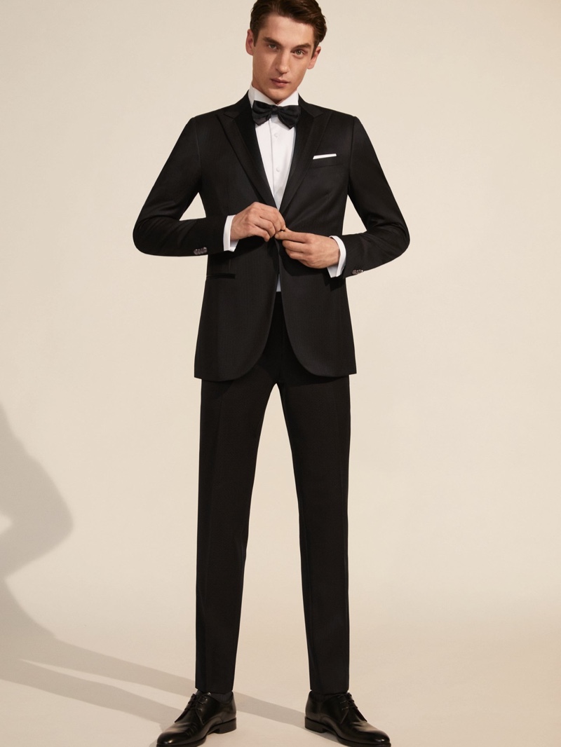 Front and center, Anatol Modzelewski dons a sharply tailored suit from Corneliani Cerimonia.