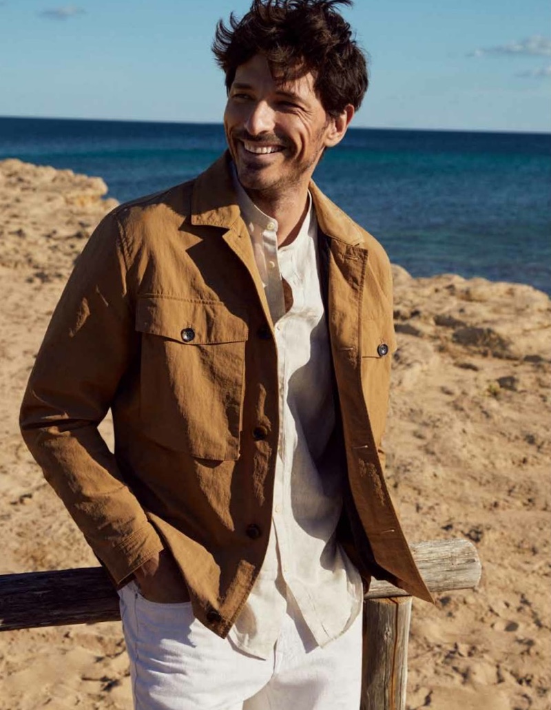 All smiles, Andres Velencoso wears a linen jacket and shirt with white jeans from Esprit's spring-summer 2021 men's collection.