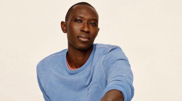 Relaxing, Armando Cabral sports a lightweight sun-faded french terry sweatshirt and jogger sweatpants from J.Crew.