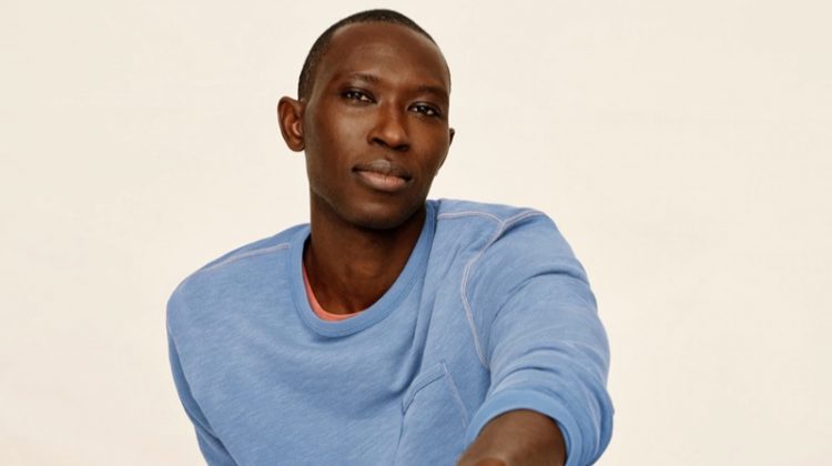 Relaxing, Armando Cabral sports a lightweight sun-faded french terry sweatshirt and jogger sweatpants from J.Crew.