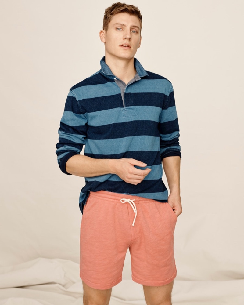 Showcasing iconic style, Mikkel Jensen models a striped J.Crew 1984 rugby shirt with lightweight sun-faded french terry dock shorts.