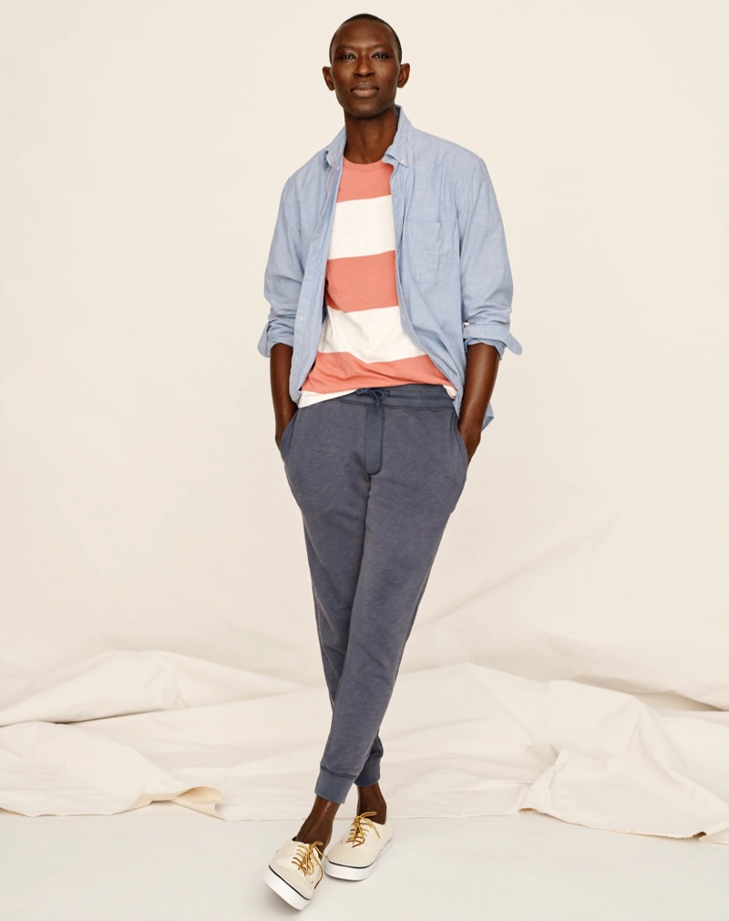 Going casual, Armando Cabral sports a J.Crew slim broken-in organic cotton oxford shirt, striped slub jersey pocket t-shirt, and lightweight sun-faded french terry jogger sweatpants.