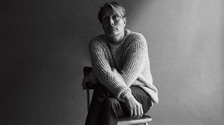Mads Mikkelsen dons an Isabel Marant sweater with a Nanushka t-shirt, and A.P.C. jeans for WSJ Magazine.