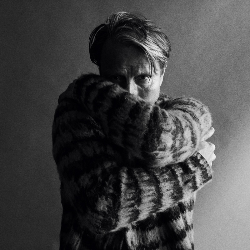 Connecting with WSJ Magazine for a new photoshoot, Mads Mikkelsen dons a Saint Laurent sweater.