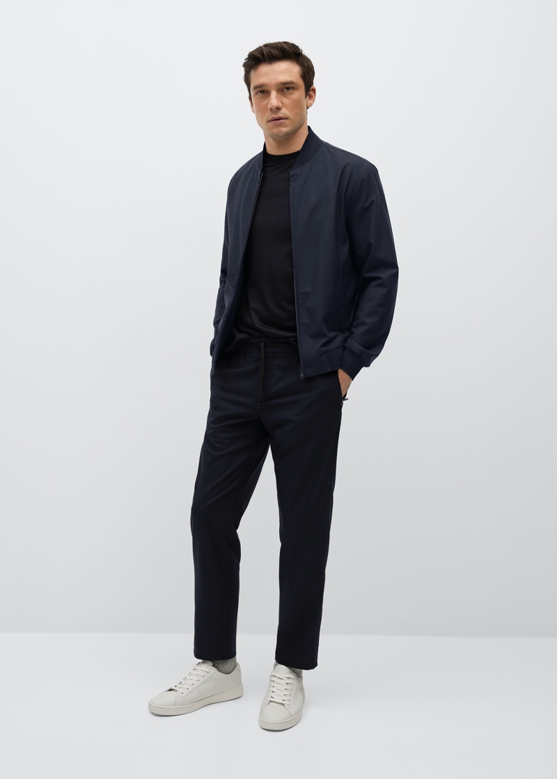 Alexis Petit models a technical merino wool bomber with pants from Mango's performance collection.