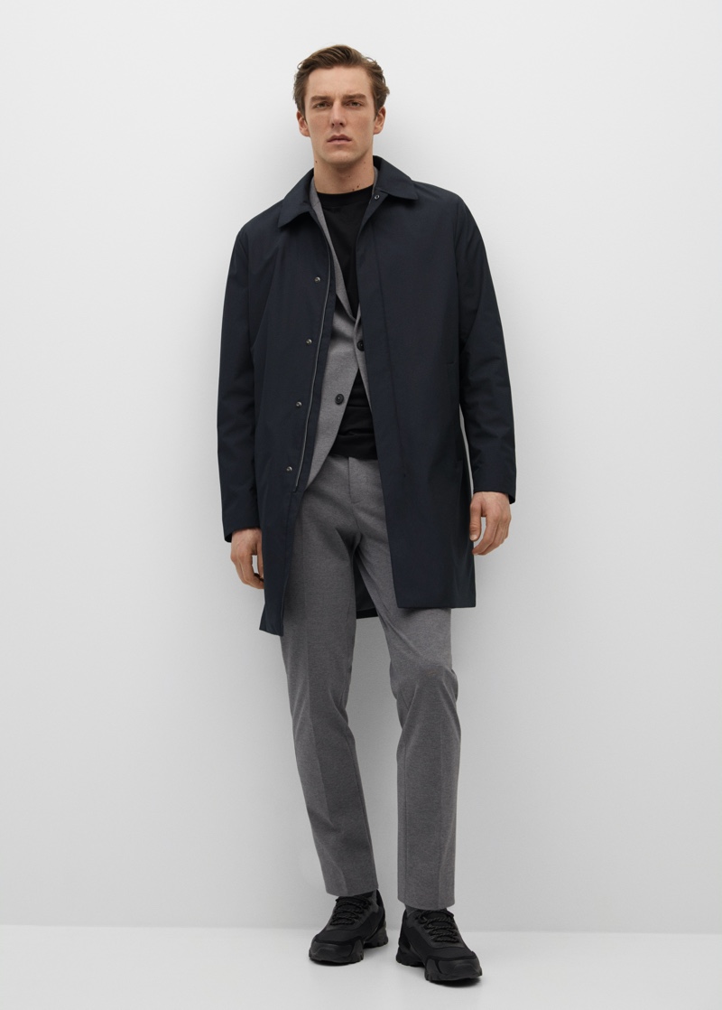 Donning a look from Mango's performance collection, Quentin Demeester wears a lightweight coat with a technical fabric suit.