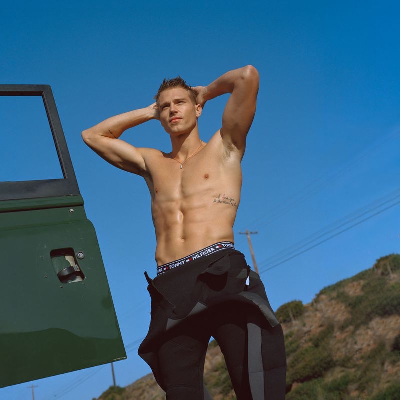 Stripping out of his wetsuit, a shirtless Matthew Noszka stars in Tommy Hilfiger's spring-summer 2021 men's campaign.
