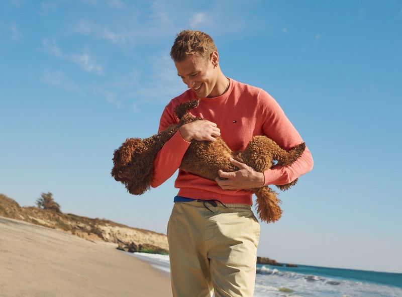 All smiles, Matthew Noszka shares the spotlight with a small dog for Tommy Hilfiger's spring-summer 2021 men's campaign.