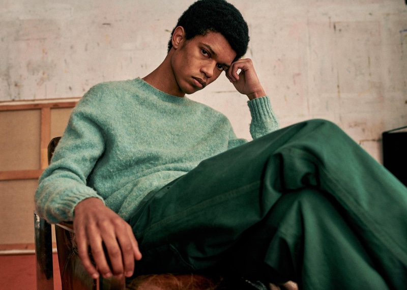 Sporting a sweater, Ruben Boa wears colored denim jeans from Octobre Editions.