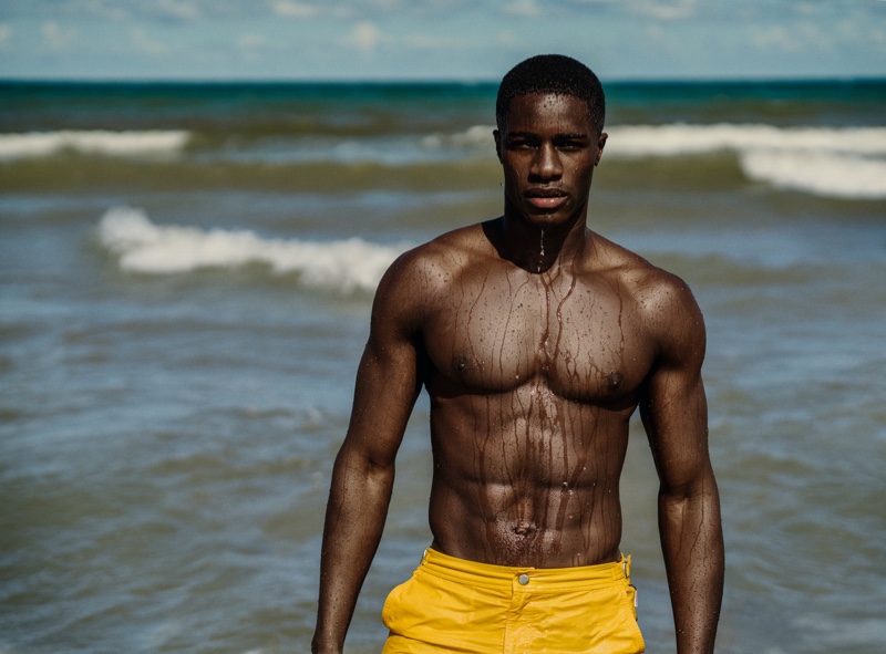 James Kakonge stands out in yellow swim shorts for Orlebar Brown's spring 2021 campaign.