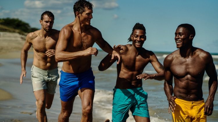 Models Andrew Cooper, Ollie Edwards, Ty Ogunkoya, and James Kakonge sport swimwear from Orlebar Brown's Atlantic collection.