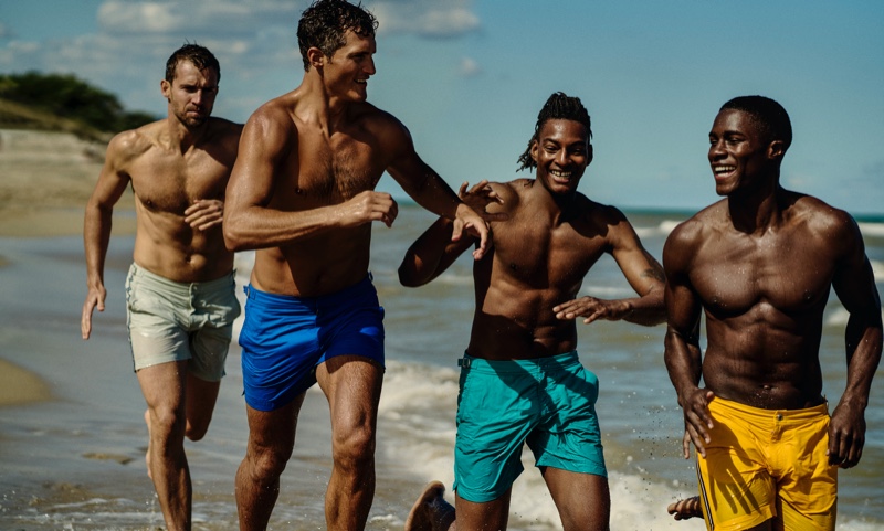 Models Andrew Cooper, Ollie Edwards, Ty Ogunkoya, and James Kakonge sport swimwear from Orlebar Brown's Atlantic collection.