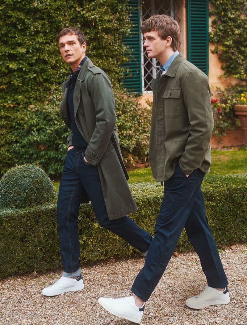 Taking a stroll, models Alexandre Cunha and Benjamin Eidem wear essentials like the trench coat for OVS Piombo's spring-summer 2021 campaign.