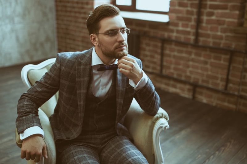 Siting Man Checkered Suit Bow Tie