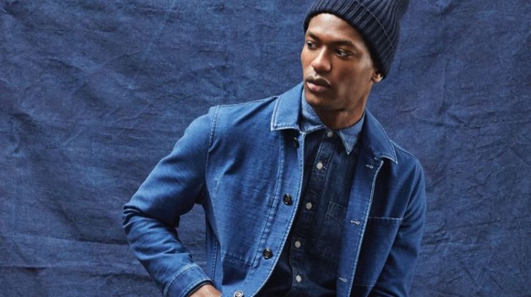 Hamid Onifade dons an indigo Japanese French chore coat and denim button-down shirt from Todd Snyder.