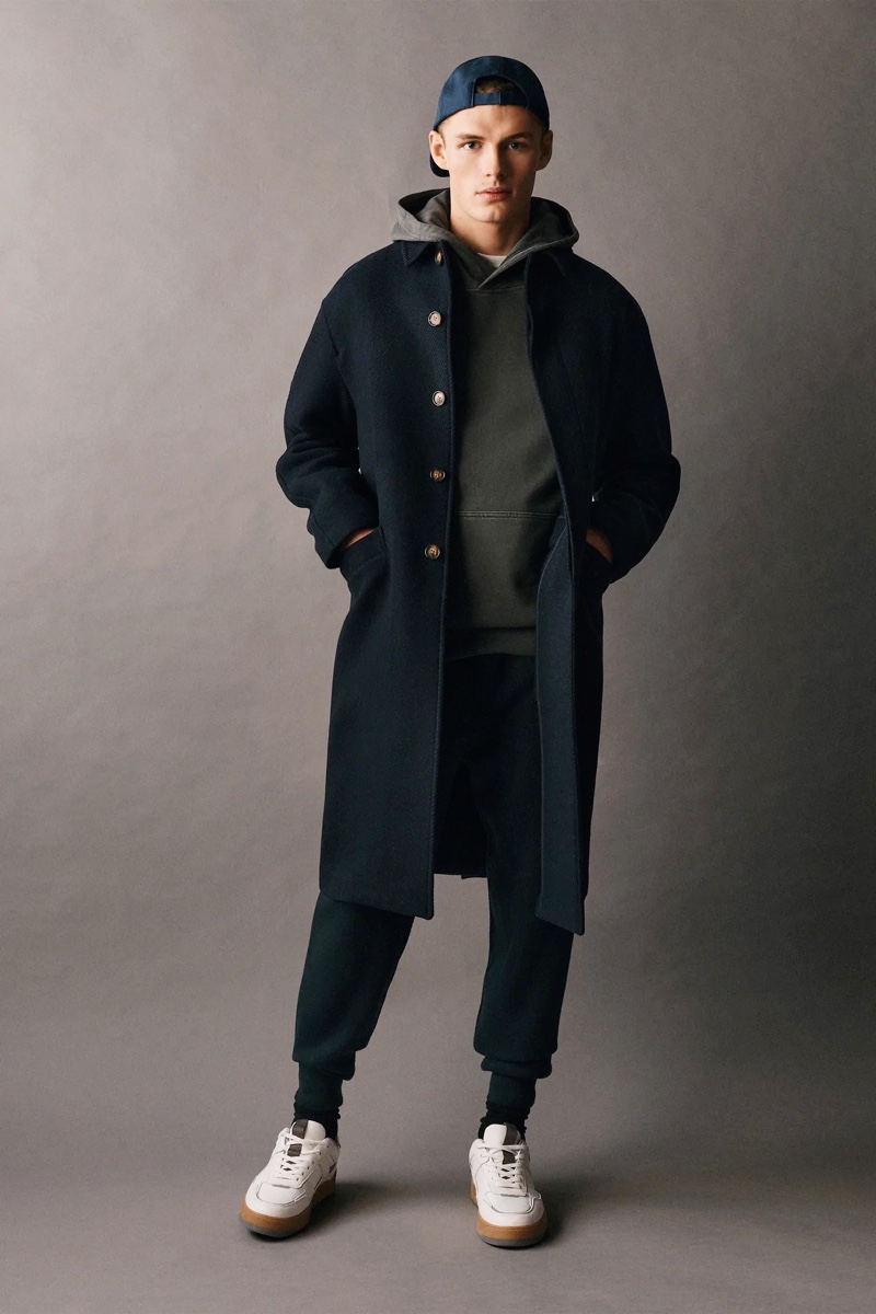 Rocking an oversized coat and leisurewear, Finley Prentice wears Zara Man.