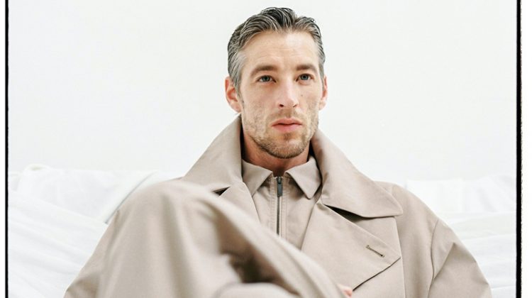 Rocking an oversized trench, Joel Frampton models the latest menswear from Adolfo Dominguez.