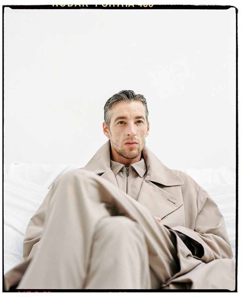 Rocking an oversized trench, Joel Frampton models the latest menswear from Adolfo Dominguez. 