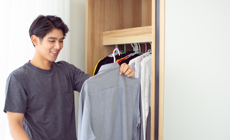 Asian Man Closet Choosing Shirt