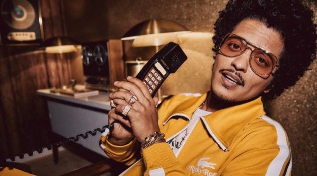 Bruno Mars Brings Retro Charm to Lacoste with Ricky Regal Collection Bruno Mars rocks a yellow tracksuit from his Lacoste Ricky Regal collection.