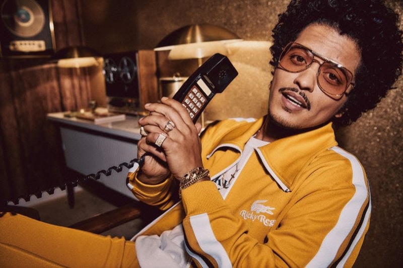 Bruno Mars rocks a yellow tracksuit from his Lacoste Ricky Regal collection.