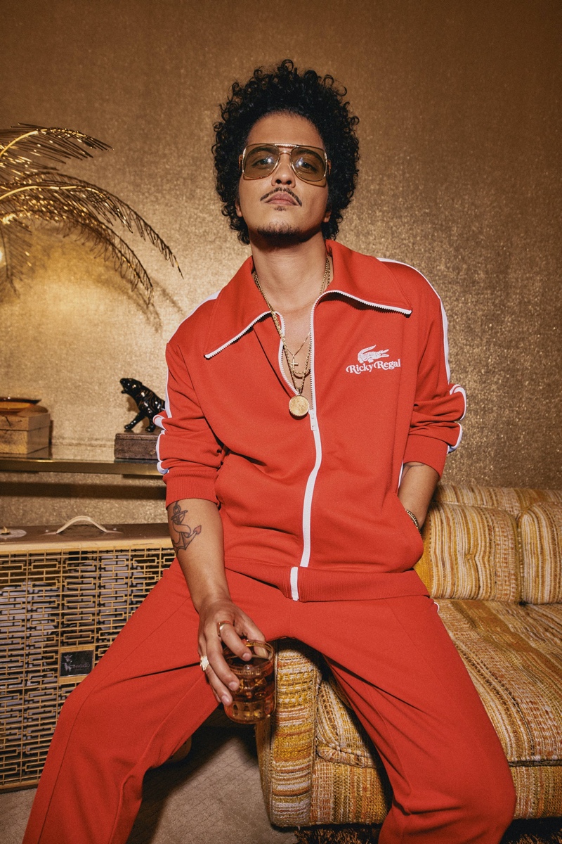 Front and center, Bruno Mars rocks a red tracksuit from his Lacoste Ricky Regal collection.