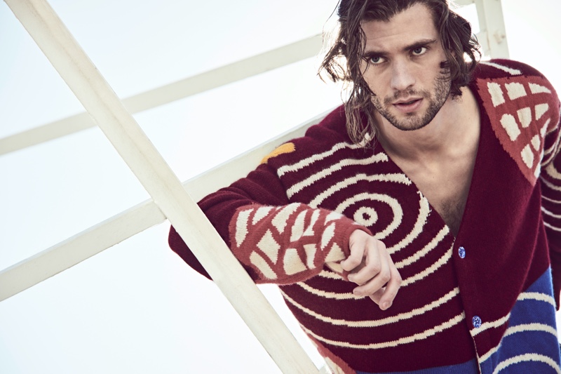 Connecting with Mytheresa for its spring-summer 2021 campaign, David Corenswet wears a chunky cardigan by The Elder Statesman.