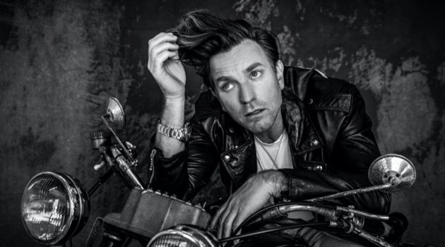 Ewan McGregor Covers VMAN, Dishes on Playing Halston Rocking a Celine leather biker jacket, Ewan McGregor also wears a Tiffany & Co. necklace and TAG Heuer watch for VMAN.