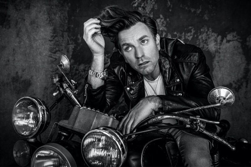 Rocking a Celine leather biker jacket, Ewan McGregor also wears a Tiffany & Co. necklace and TAG Heuer watch for VMAN.