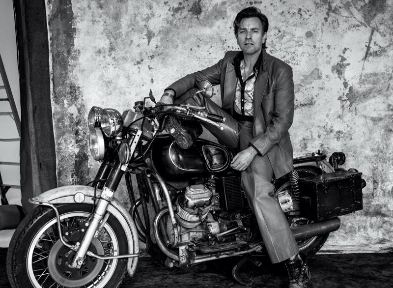 Posing on a motorcycle, Ewan McGregor dons a Gucci suit for his VMAN cover photoshoot. 