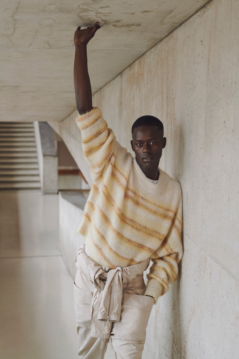 Alpha Dia models a chic neutral-colored look from Isabel Marant's spring-summer 2021 men's collection.