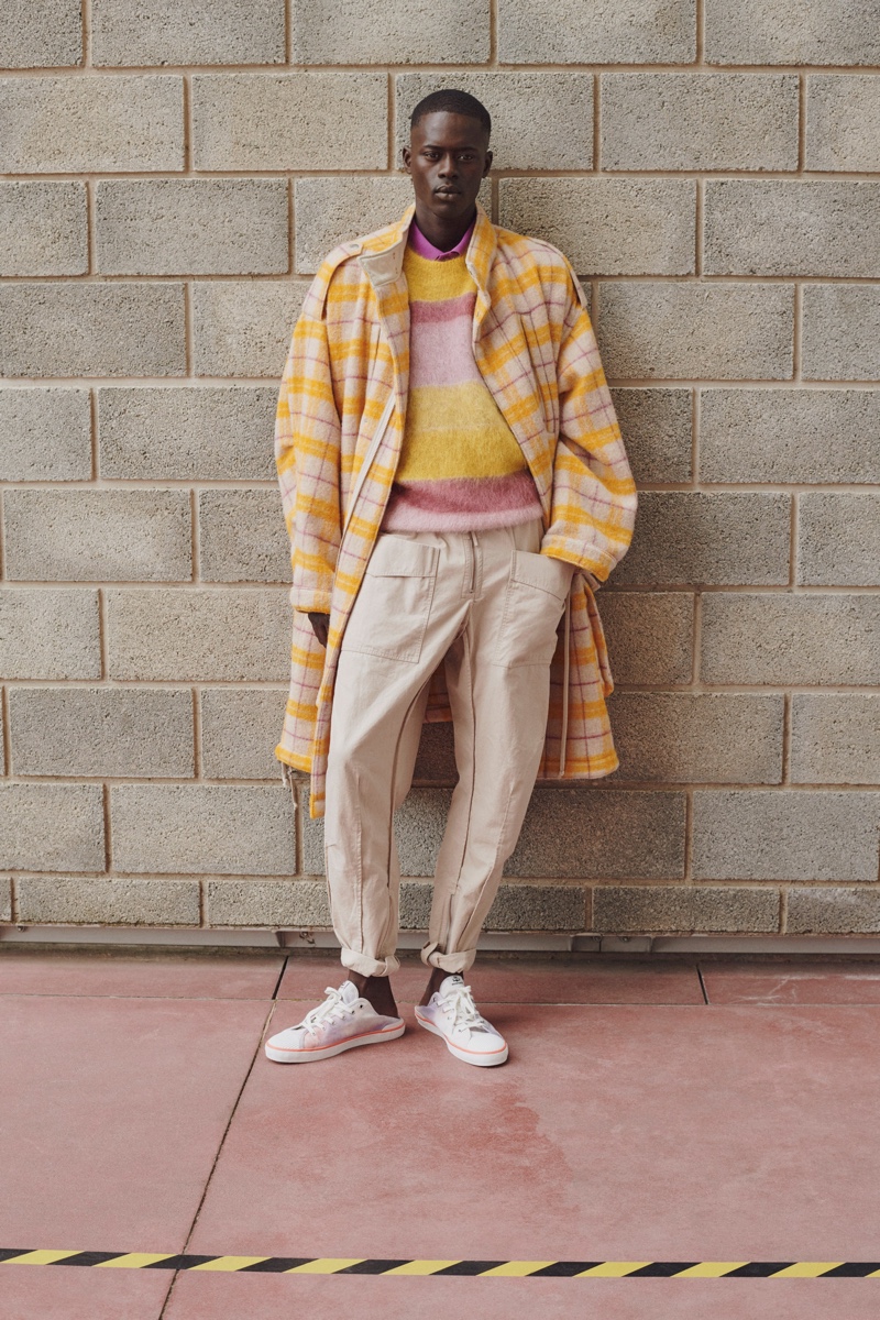 Front and center, Alpha Dia makes a statement in a splash of yellow with a check coat from Isabel Marant's spring-summer 2021 men's collection.