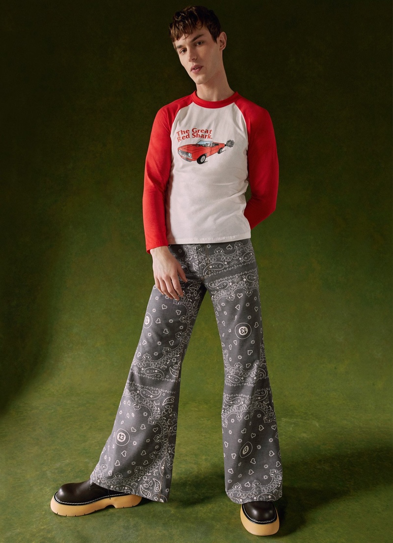 Embracing a retro attitude, Kit Butler dons a Natasha Zinko car-motif t-shirt with wide-leg bandana trousers from Harrods.