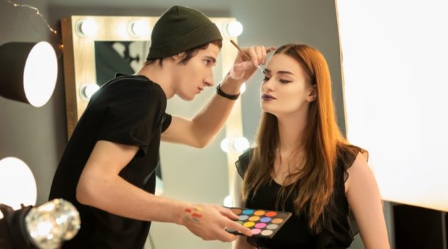 How Can You Benefit from a Career in Beauty Male Makeup Artist Applying Brush Model Face