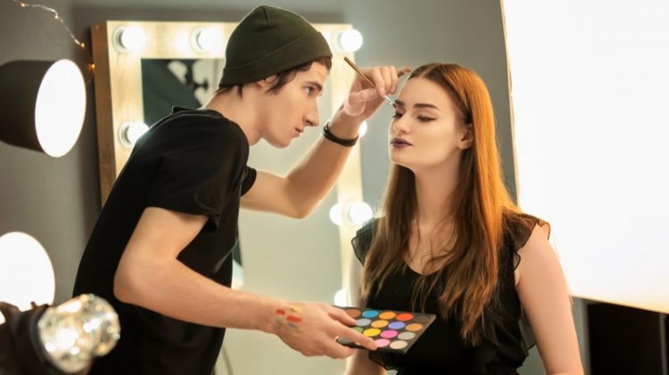 Male Makeup Artist Applying Brush Model Face
