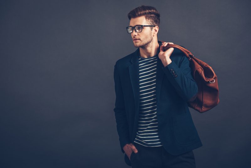 Male Model Carrying Leather Bag Striped Shirt Blazer Glasses