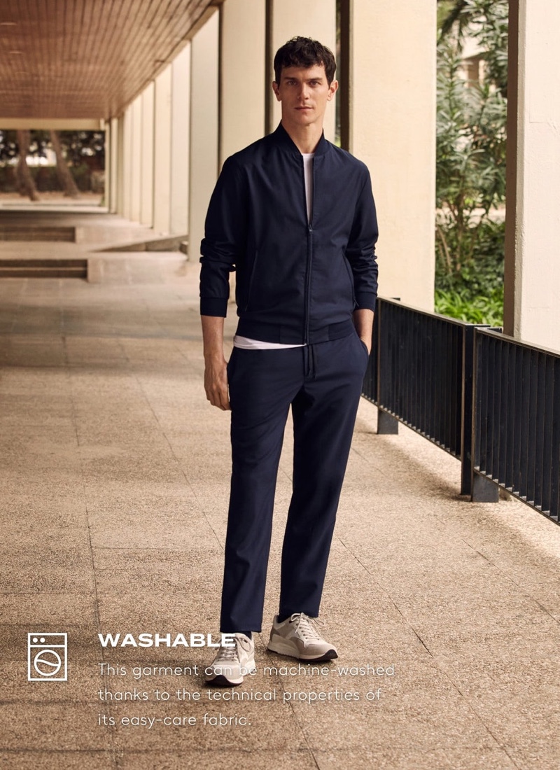 Embracing a navy look from Mango's High-Performance collection, Vincent Lacrocq wears packable collection technical woolen pants.