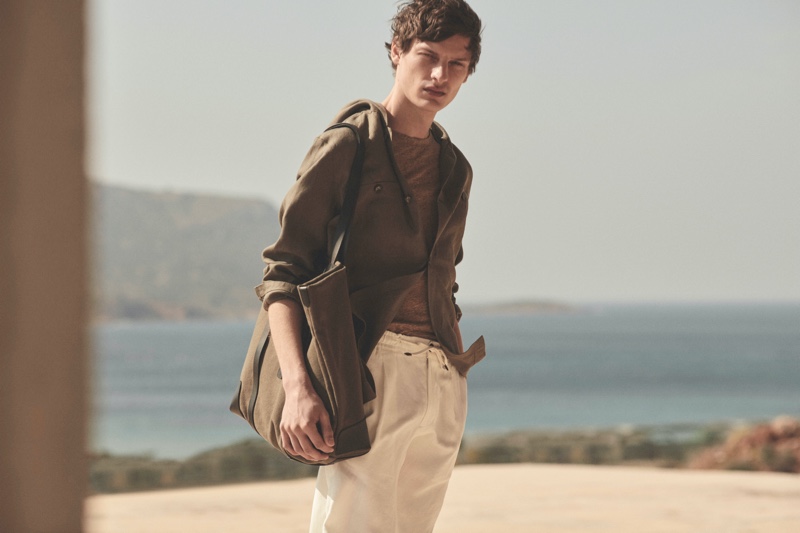 Sporting chic neutrals, Valentin Caron models a 100% linen hooded overshirt from Massimo Dutti's spring 2021 Limited Edition collection.