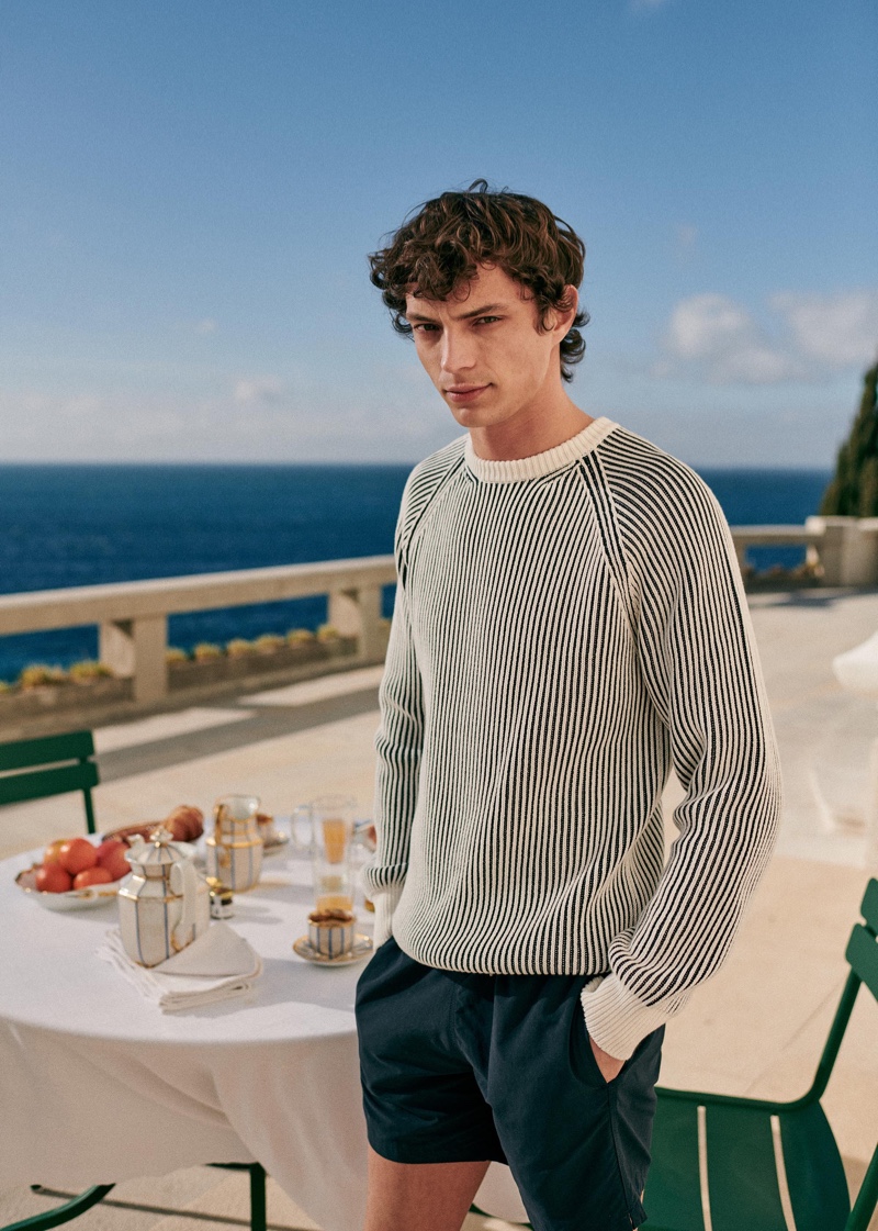 Offering up a beach-worthy look, Andrea Quaranta sports an Octobre sweater with shorts.