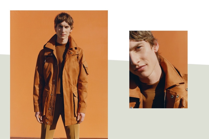 Front and center, Thom Voorintholt dons a hooded parka, sweatshirt, and jersey trousers by Reserved.