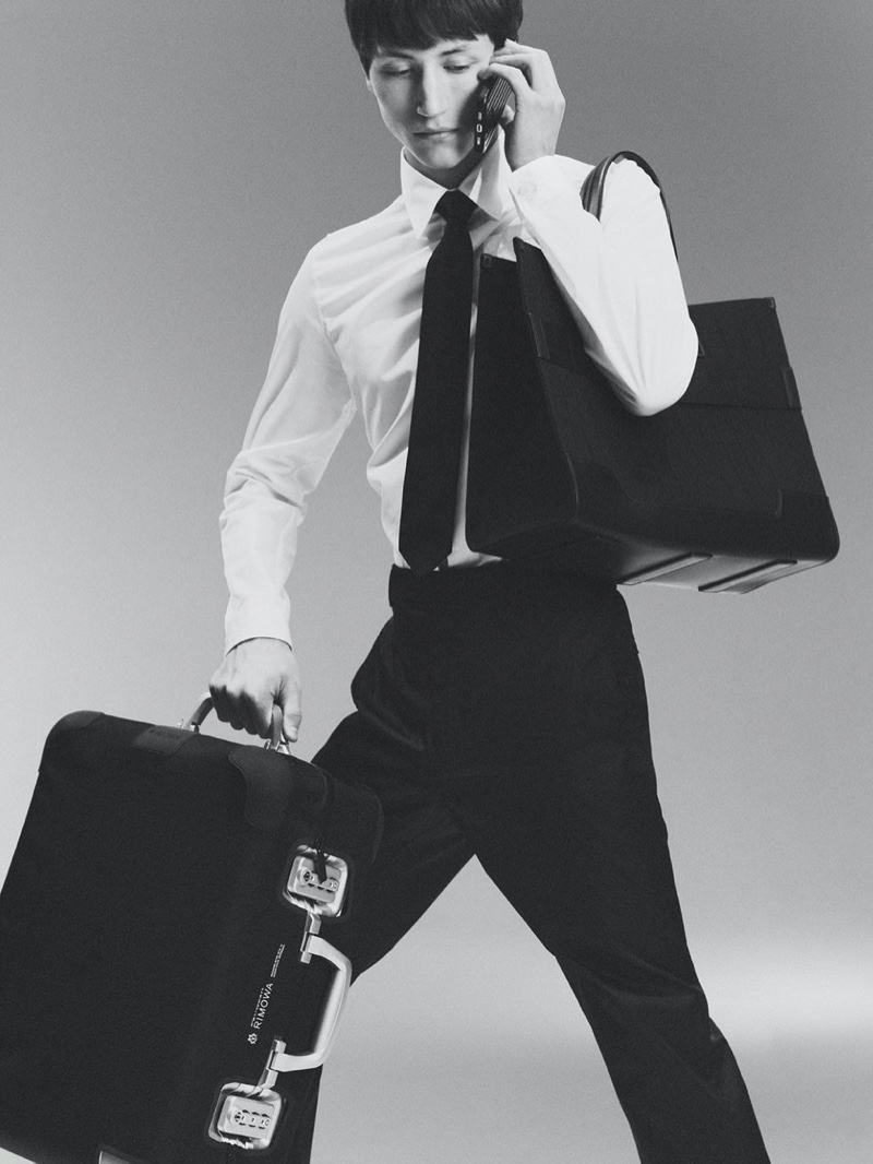 Donning a business look, Felix Cerutti appears in RIMOWA's spring-summer 2021 campaign.