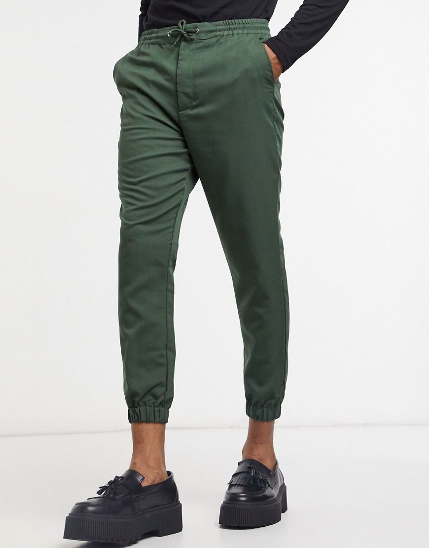 green tapered trousers